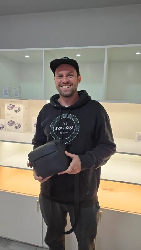 Customer smiling with his drone bag at the shop